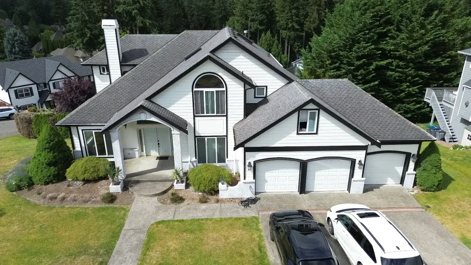 A two-story Pacific Northwest home with a new charcoal shingle roof